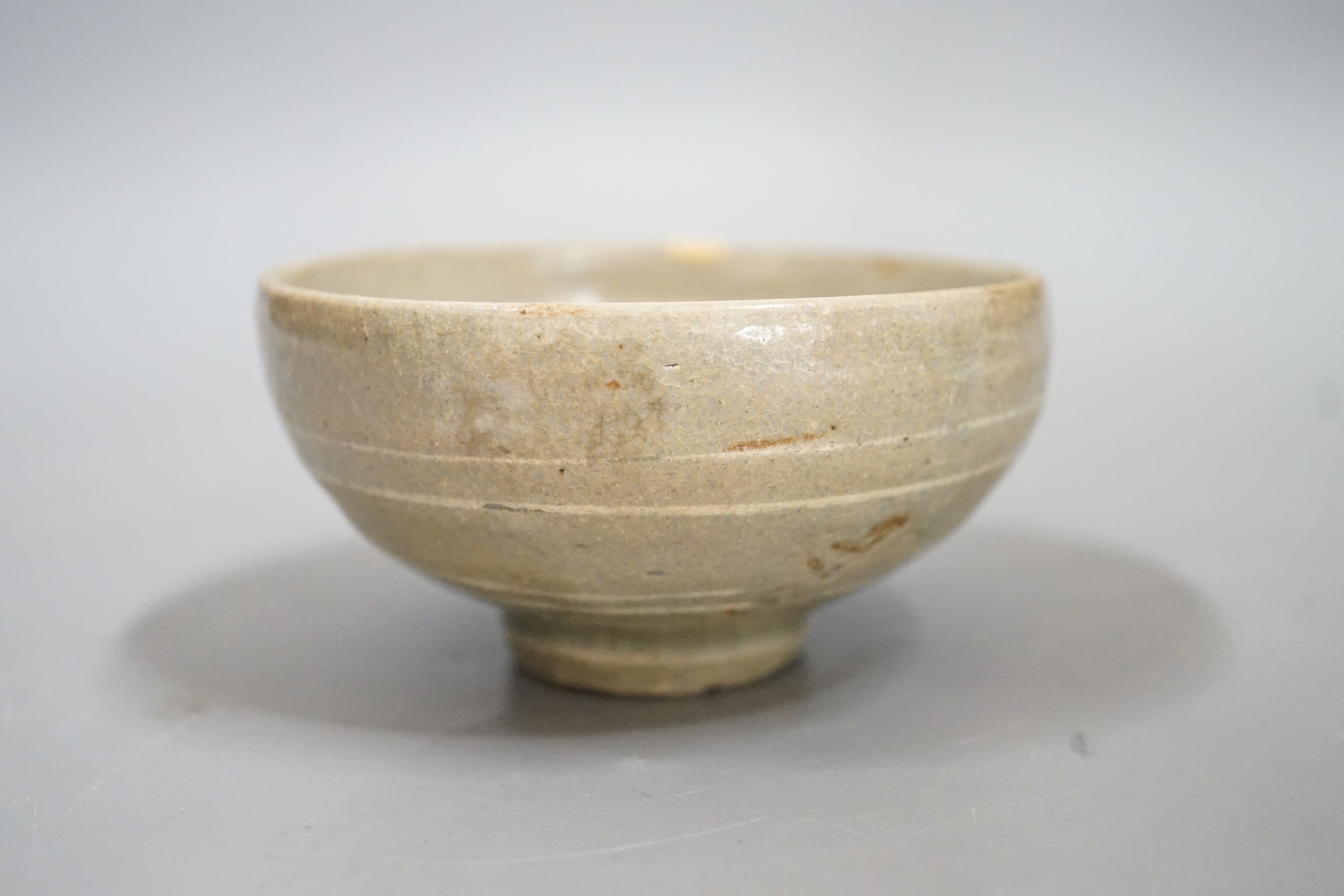 A Korean slip decorated celadon small bowl, Koryo dynasty. 10cm diameter